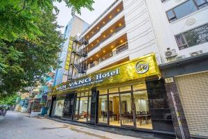 a building with a yellow sign for a hotel at Sen Vàng Hotel in Sầm Sơn