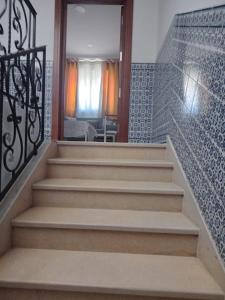 a staircase in a house with a glass door and stairs at Dar Momo in Nabeul