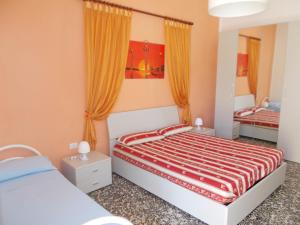 A bed or beds in a room at Appartamenti Blue House