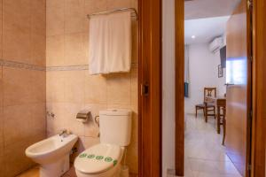 a bathroom with a toilet and a sink at Hotel Club Sunway Punta Prima in Es Pujols