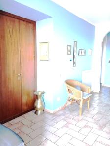 a living room with a chair and a wooden door at Borgo San Savino in San Savino