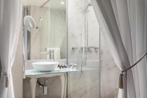 a bathroom with a sink and a shower at Mystery Hotel Budapest in Budapest