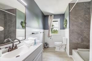 a bathroom with a sink and a toilet at Dry Ridge Farmhouse with Hot Tub and Game Room! in Dry Ridge +30 photos