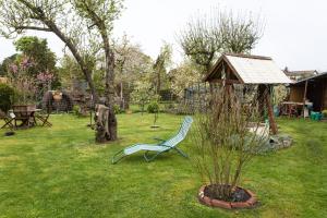 a green chair sitting in the grass in a yard at Ferienwohnung Gustel in Freest