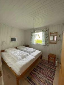 A bed or beds in a room at Summer House At Hvidbjerg Beach With Sea View