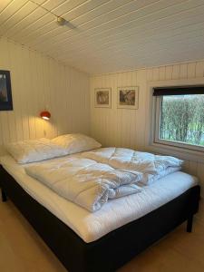 A bed or beds in a room at Summer House At Hvidbjerg Beach With Sea View