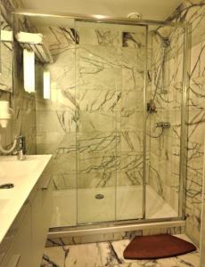 a shower with a glass door in a bathroom at Angel apartmens in Wrocław