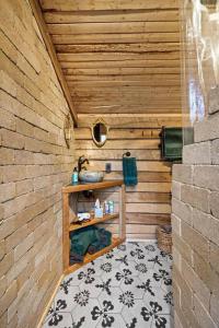 a bathroom with a sink in a wooden wall at Creekside Cabin in Florence