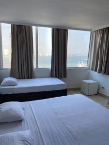 Postel nebo postele na pokoji v ubytování Hotel Cartagena Premium