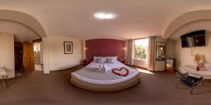 a bedroom with a large bed with a red heart on it at Hotel Maison Du Solei in Arequipa