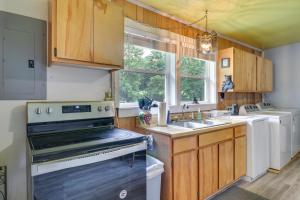 a kitchen with a stove and a sink at Pet-Friendly Cashiers Cabin Fire Pit, Near Lakes! in Cashiers