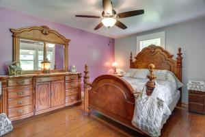a bedroom with a large wooden bed and a dresser at Pet-Friendly Cashiers Cabin Fire Pit, Near Lakes! in Cashiers