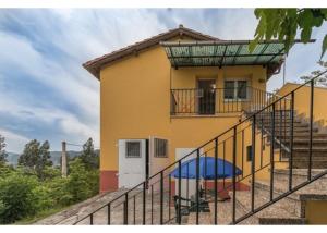 a house with stairs leading up to it at El Trabaz in Candamo