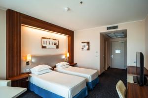 A bed or beds in a room at Delta Hotels by Marriott Olbia Sardinia