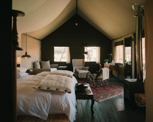 a bedroom with a large bed and a living room at PUQIO by Andean in Yanque