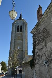 a building with a clock tower with a street light at B&B chez Sylvain in Beaugency