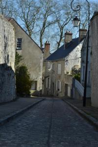 an empty cobblestone street in an old town at B&B chez Sylvain in Beaugency