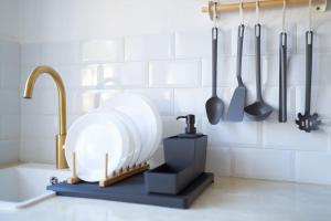 a kitchen with a sink and utensils on the wall at Lirondo in San José