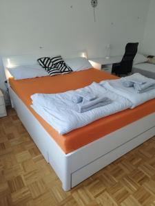 a bed in a room with an orange mattress at Apartma MB center in Maribor