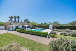 a house with a swimming pool in a yard at Casa Blanca in El Port de la Selva