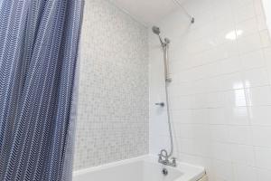 a bathroom with a shower curtain and a tub at Beautiful & comfortable home in Stockton-on-Tees