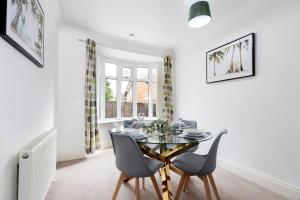a dining room with a glass table and chairs at Beautiful & comfortable home in Stockton-on-Tees