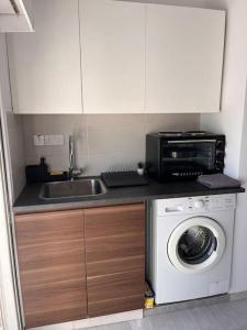 a kitchen with a sink and a washing machine at Top floor Flat in Nicosia 2 in Nicosia