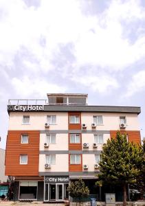 a hotel with a sign on top of it at MD CITY HOTEL in Canakkale