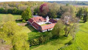 an aerial view of a large house in a field at Piscine - Domaine de Wolphus - 15 min de la mer in Zouafques