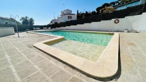 a swimming pool in the middle of a patio at Mediterranean house, pool, beach and charm garden in Arenys de Mar