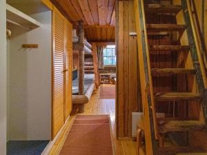 a hallway of a cabin with wooden floors and stairs at Holiday Home Keidaskero b 9 by Interhome in Pyhätunturi