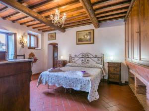 a bedroom with a bed and a table in it at Apartment Mangiatoia by Interhome in Greve in Chianti