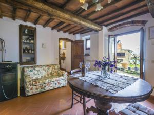 a living room with a table and a couch at Apartment Mangiatoia by Interhome in Greve in Chianti