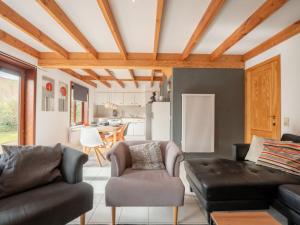 een woonkamer met een bank en een stoel bij Holiday Home Casa by Interhome in De Haan
