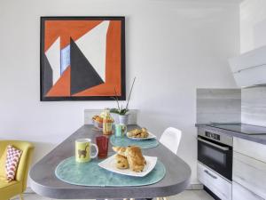 einen Küchentisch mit zwei Teller Essen drauf in der Unterkunft Apartment Les Terrasses d'Azur-2 by Interhome in Sanary-sur-Mer