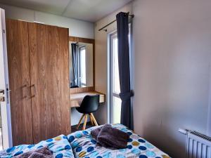 una camera con un letto e una sedia e una finestra di Holiday Home Tiny Haus Central by Interhome a Beilngries