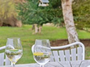 two wine glasses sitting on top of a table at Holiday Home Kara - all inclusive - 450m from the sea by Interhome in Gilleleje