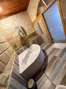 a bathroom with a white sink in a brick wall at Tokmak Konukevi in Avanos