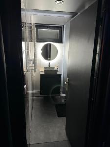 a bathroom with a sink and a mirror at Flower by cloud in Aubervilliers