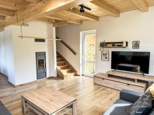 a living room with a couch and a tv at Holiday Home Chalupa 13ka by Interhome in Smržovka