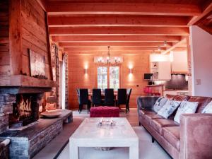a living room with a couch and a fireplace at Chalet Chalet Olivier by Interhome in Villars-sur-Ollon