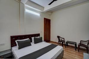 a bedroom with a bed and two chairs in it at OYO Hotel AXN RESORT in Panchli