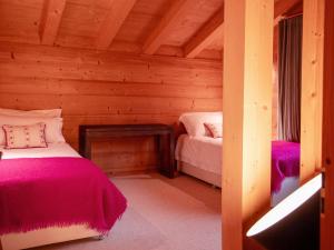 a bedroom with two beds in a log cabin at Chalet Chalet Olivier by Interhome in Villars-sur-Ollon