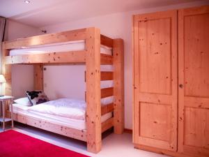 a bunk bed in a room with a door at Chalet Chalet Olivier by Interhome in Villars-sur-Ollon