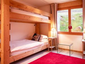 a bedroom with a bunk bed and a window at Chalet Chalet Olivier by Interhome in Villars-sur-Ollon