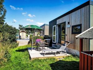 a patio with a table and chairs and an umbrella at Holiday Home Tiny Haus Sonnendeck by Interhome in Beilngries