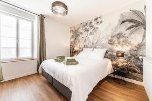 a bedroom with a large bed and a large window at Le Clos de la Jouvence - Gite 4* à 15 minutes du Puy du Fou, 6 personnes in Saint-Laurent-sur-Sèvre