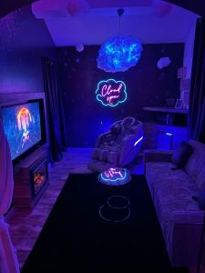 a living room with a neon sign on the wall at Flower by cloud in Aubervilliers