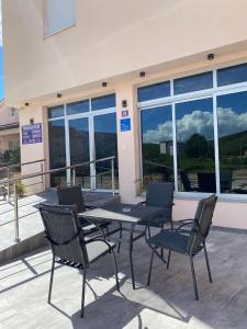 a table and chairs in front of a building at Pansion Maglica in Međugorje