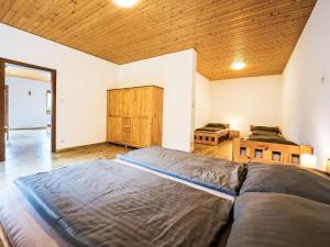 a bedroom with two beds and a wooden ceiling at Apartment Pod Černou Studnicí-3 by Interhome in Nova Ves nad Nisou